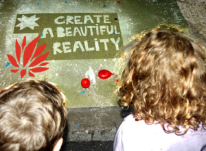 "Create a Beautiful Reality" Rainworks sidewalk art at the 2016 Lotus World Music & Arts Festival. Photo by Michael Redman.